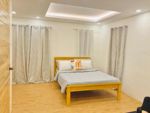 a bedroom with a bed and a window with curtains at Selah Nordic Guest house, with Wi-Fi, & Netflix in Palo