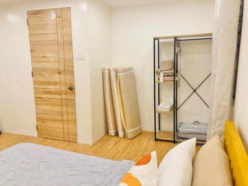 a room with a bed and a closet and a door at Selah Nordic Guest house, with Wi-Fi, & Netflix in Palo