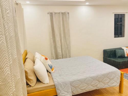 a bedroom with a bed with pillows on it at Selah Nordic Guest house, with Wi-Fi, & Netflix in Palo