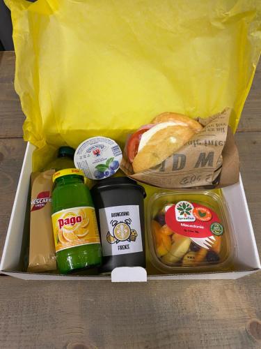a lunch box with food and a sandwich and bread at Corsini Tintori in Florence