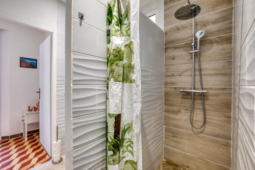 a bathroom with a shower with a wooden wall at Gîte A La Bonne Franck'ette in Aspiran