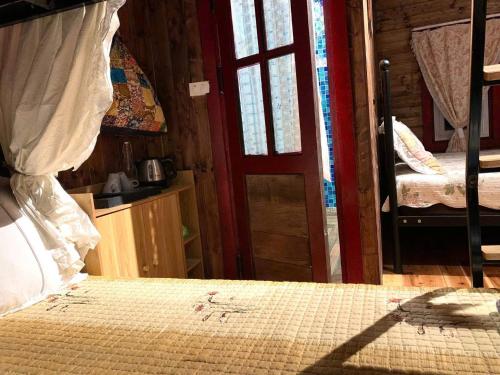 a bedroom with a bed and a door to a room at Khu nghỉ dưỡng Ba Hạt Dẻ in Sóc Sơn