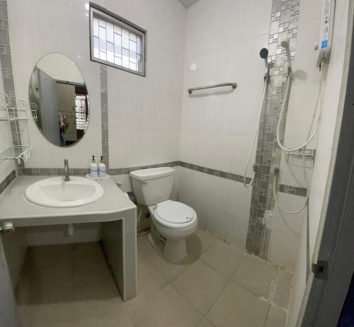 a bathroom with a toilet and a sink and a shower at บ้านมาดาม เขาใหญ่ in Ban Chek