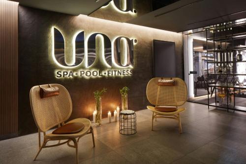 a restaurant with two chairs and a sign on the wall at Four Points by Sheraton Prishtina City in Pristina