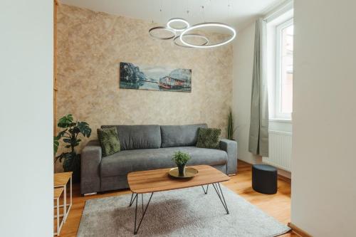 a living room with a couch and a table at Apartmány J&J in Šumperk