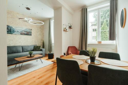 a living room with a table and a couch at Apartmány J&J in Šumperk
