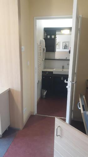 an open door to a kitchen with a sink at Terrasses de Labrau - piscine in Allos