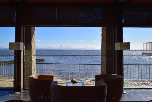a view of the ocean from a restaurant with a table and chairs at Pousada da Ria in Torreira