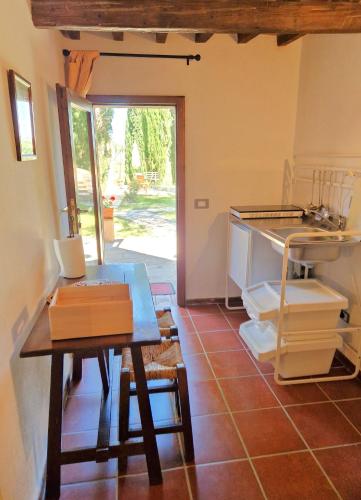 a room with a table and a table and a door at Borgo Melograno in Chiusi
