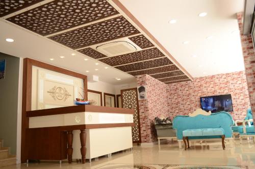 a living room with a tv and some chairs at Sinop Dolunay Hotel in Sinop