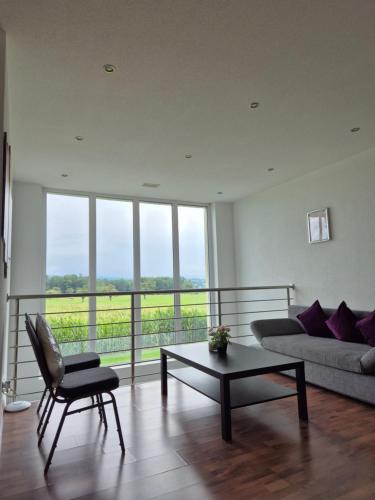 a living room with a couch and a table at JM Swiss Space in Langrickenbach