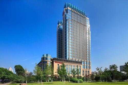 a tall building with a park in front of it at Sheraton Wenzhou Hotel in Wenzhou