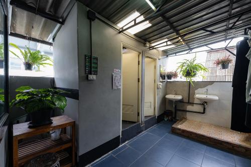 a bathroom with two sinks and two toilets at KAYAN Hostel in Chiang Mai