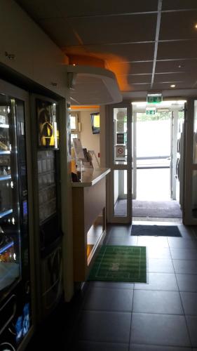 a kitchen with a counter and a door to a room at ibis budget Orly Rungis in Rungis