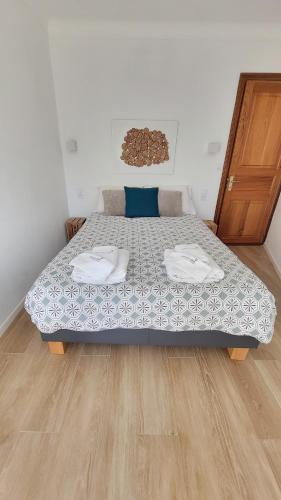 a large bed in a room with a wooden floor at DOMAINE CARDU in Cardo-Torgia
