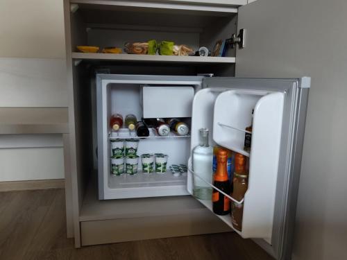 an open refrigerator filled with lots of food and drinks at Celest Boutique Urban Hideaway in Braşov