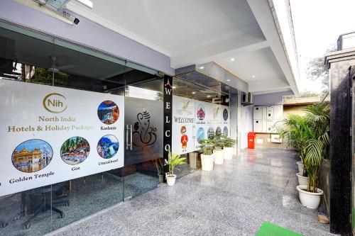 a lobby of a building with potted plants at FabHotel La Corporate Suite in Noida