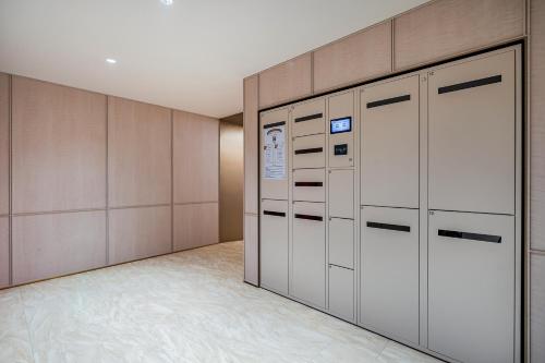 a walk in closet with lockers in a room at Hanting Hotel Beijing Zhongguancun Xueyuan Bridge Subway Station in Beijing
