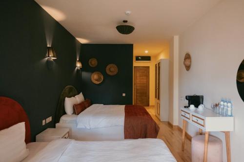 a bedroom with two beds and a green wall at Nekresi Estate in Kvareli