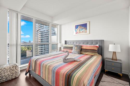 a bedroom with a bed with a swan on it at Cozy 1 Bedroom Dunfield Ave in Toronto