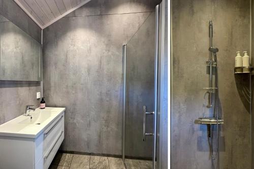a bathroom with a shower and a sink at Sea Pearl Lodge in Leknes