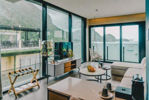 a living room with a view of the ocean at H Hotel El Nido - Vegan Friendly Hotel Managed by H Hospitality Group in El Nido