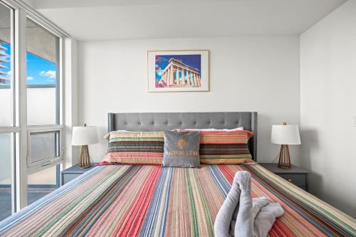 a bedroom with a bed with a striped rug at Cozy 1 Bedroom Dunfield Ave in Toronto