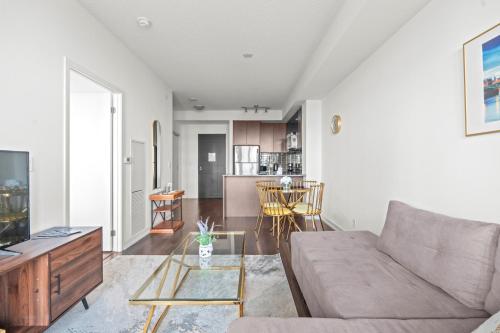 a living room with a couch and a table at Cozy 1 Bedroom Dunfield Ave in Toronto
