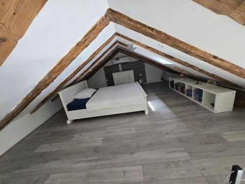 a bedroom with a bed in a attic at Kali in Kukuljanovo