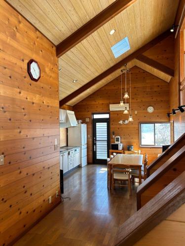 a kitchen and dining room with a table and a clock at Leo in Kō-jima