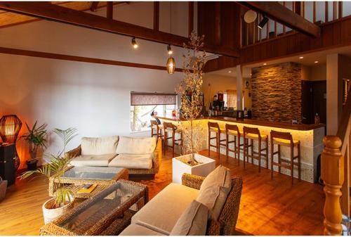 a living room with a couch and a bar at Leo in Kō-jima