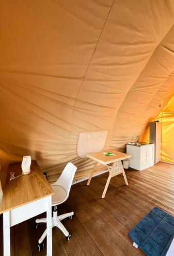 a room with a tent with a table and chairs at Reef Resort - Samal Island View Unit B7 in Kaputian