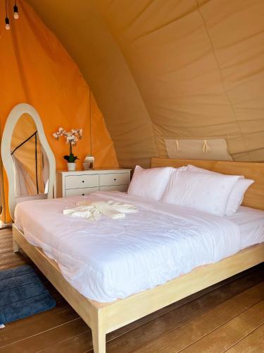 a bedroom with a bed in a tent at Reef Resort - Samal Island View Unit B7 in Kaputian