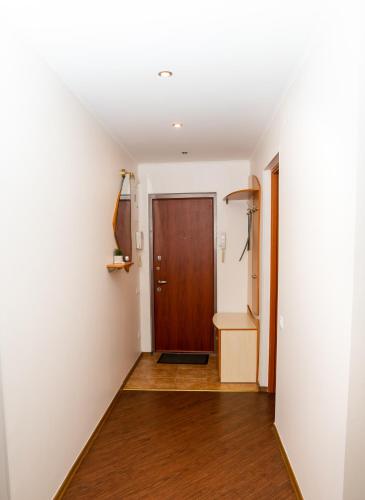 a hallway with a door and a wooden floor at Lotos for You Apartments in Mykolaiv