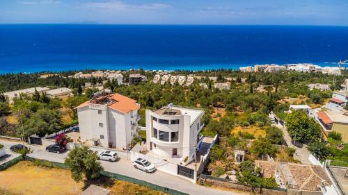 an aerial view of a building with the ocean in the background at Villa Belle Azure in Dhërmi