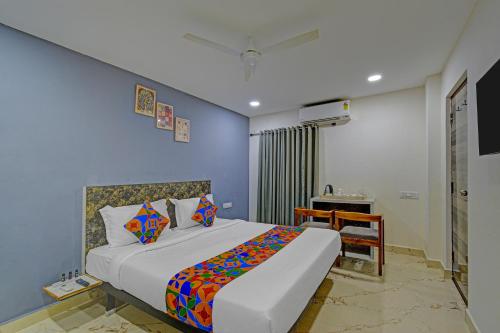 a bedroom with a bed and a desk in a room at FabHotel Rio - Nr Ramoji Filmcity, LB Nagar in Hyderabad