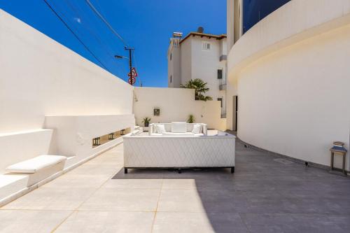 a large white room with a tub in the middle of a building at Villa Belle Azure in Dhërmi