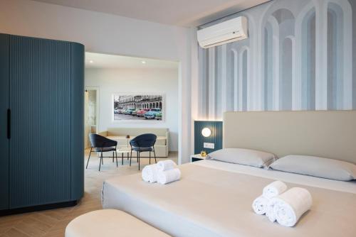 1 dormitorio con 1 cama y 2 toallas blancas en Hotel Playa Suite, en Fano