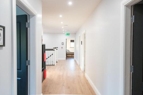 a hallway with white walls and wooden floors at Willow Valley in Monaghan