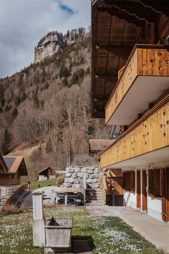 a building with a mountain in the background at Hidden Retreats The Signature in Brienzwiler