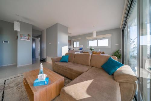 a living room with a couch and a table at Majestic Sunset Salt Lake Views 300m From Beach in Larnaka