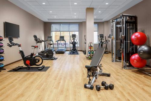 a gym with several treadmills and exercise bikes at AC Hotel by Marriott Chapel Hill Downtown in Chapel Hill