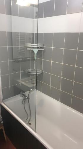 a bathroom with a shower with a glass door at Terrasses de Labrau - piscine in Allos