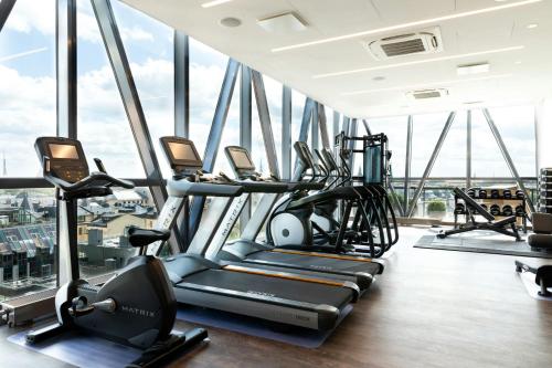 a gym with cardio equipment in a skyscraper at AC Hotel by Marriott Riga in Rīga