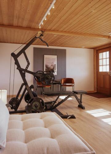 a room with a gym with a bench and a table at Hidden Retreats The Signature in Brienzwiler