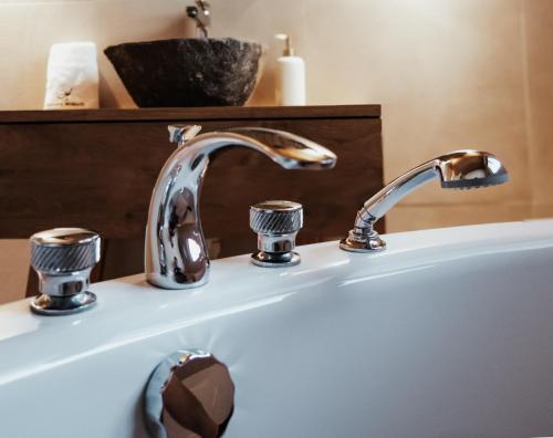 a bathroom sink with a chrome bathroom faucet at Hidden Retreats The Signature in Brienzwiler