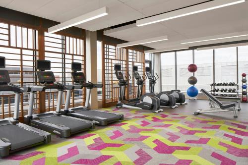 a gym with treadmills and ellipticals on a colorful carpet at Residence Inn by Marriott Washington Downtown/Convention Center in Washington