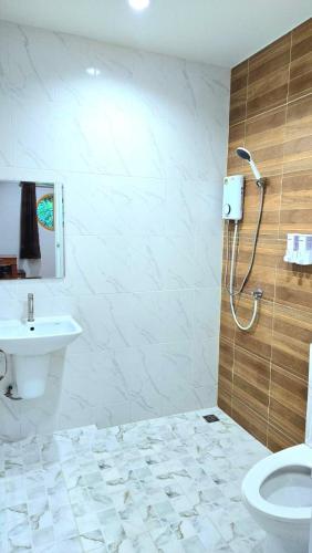 a bathroom with a shower and a toilet and a sink at Suanvadee Resort สวนวดี รีสอร์ท in Don Sak