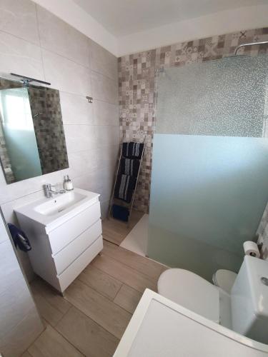 a bathroom with a sink and a toilet and a mirror at Chayofa Blue in Chayofa