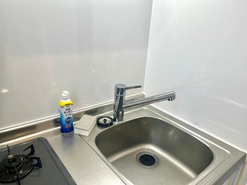 a kitchen sink with a faucet on top of it at とすアジュール in Tosu